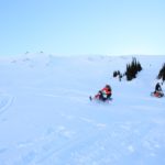 Snowmobile Tour Participants playing in alpine bowl